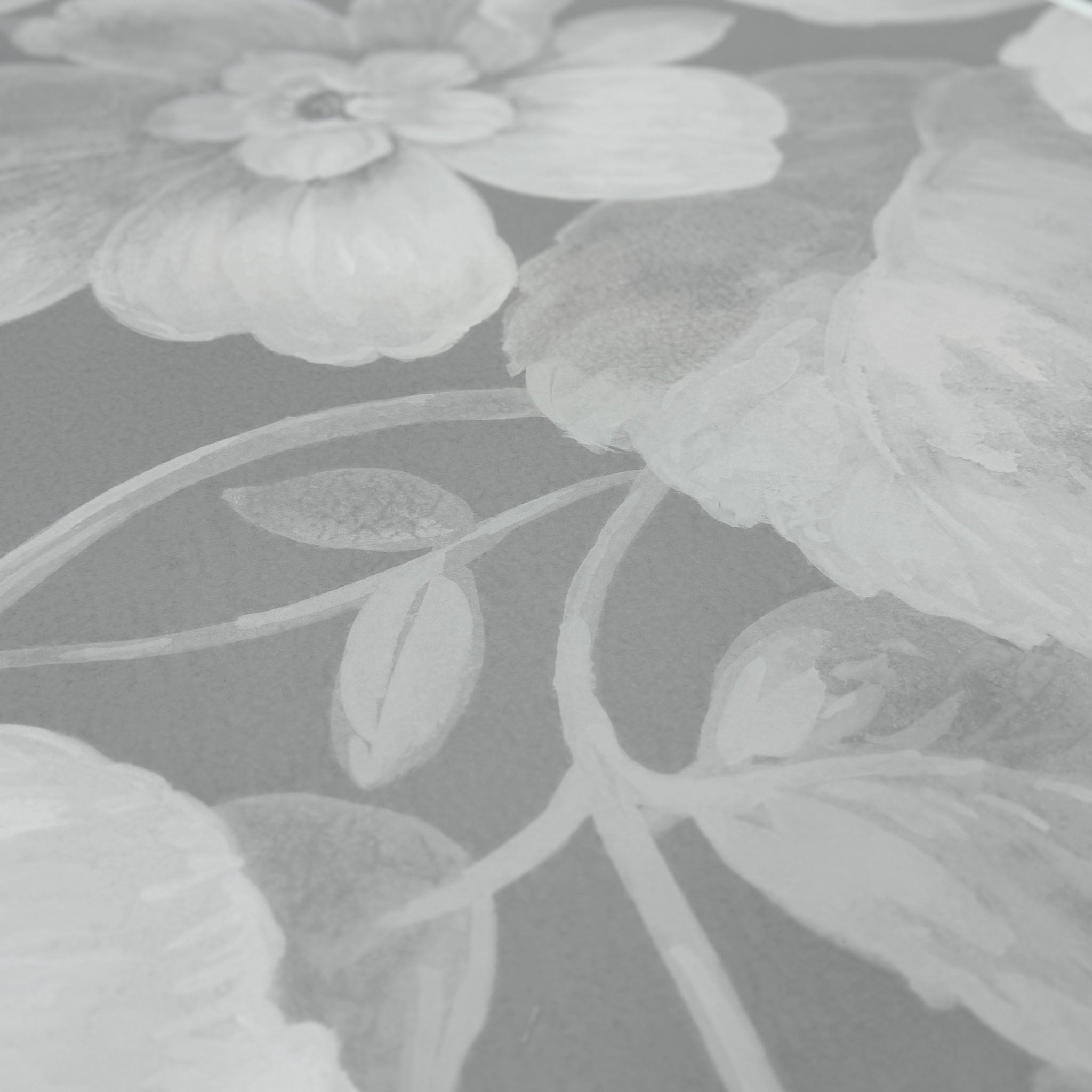 A close up view showing the detail of a matte wallpaper mural which features misty whites on dove grey floral