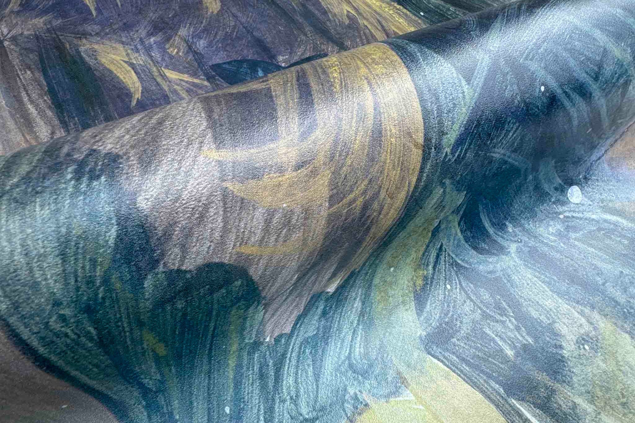 Close-up of a vibrant rainforest wallpaper mural printed on vinyl, with swirling earthy tones in an abstract style.
