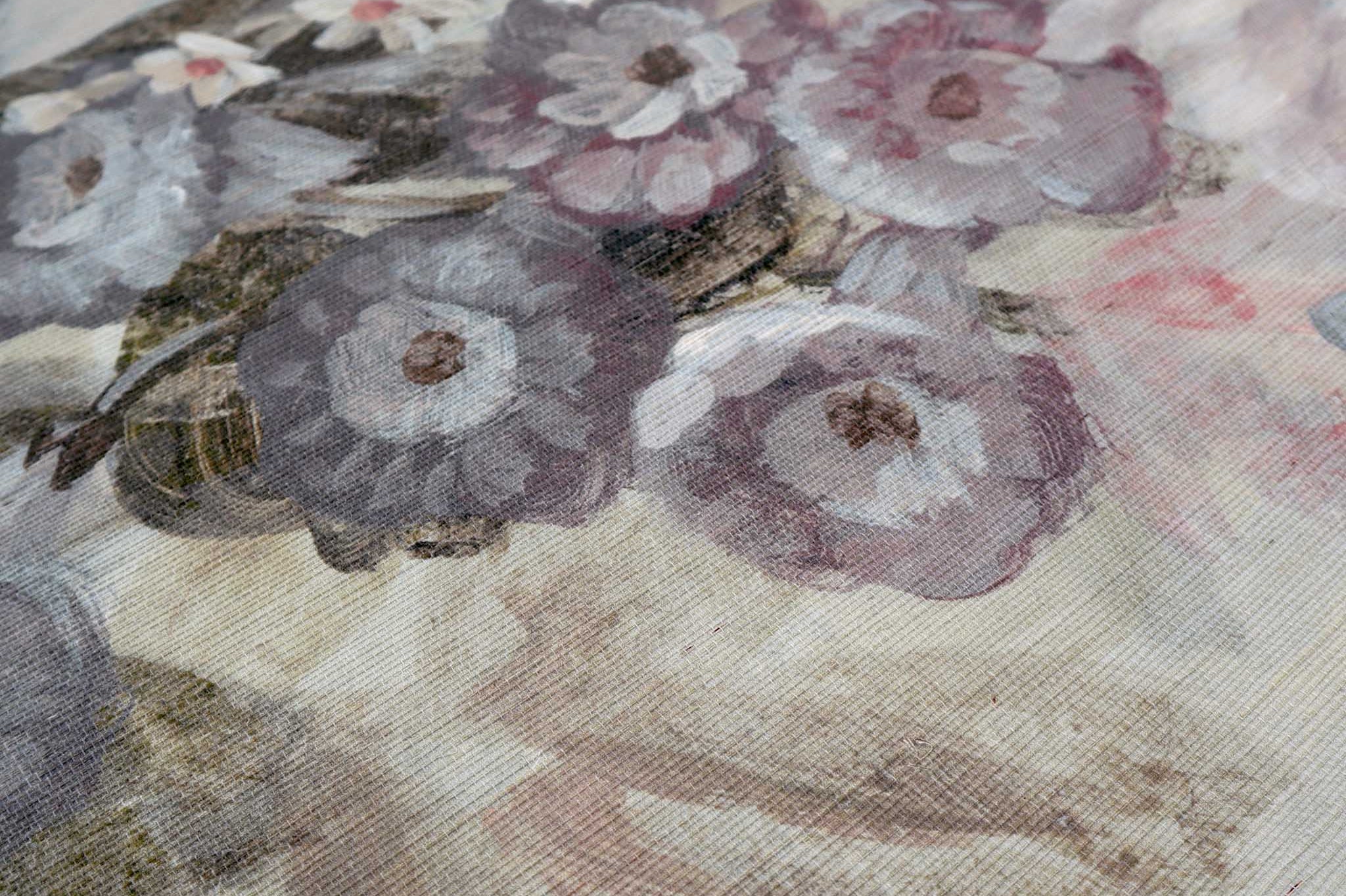 Close-up of a bespoke painted wallpaper mural featuring lush florals in soft blush pinks and muted greens on grasscloth.