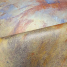 Close-up of a hand-painted panoramic wallpaper mural featuring rich tones of charcoal, rust, and ochre printed on vinyl.