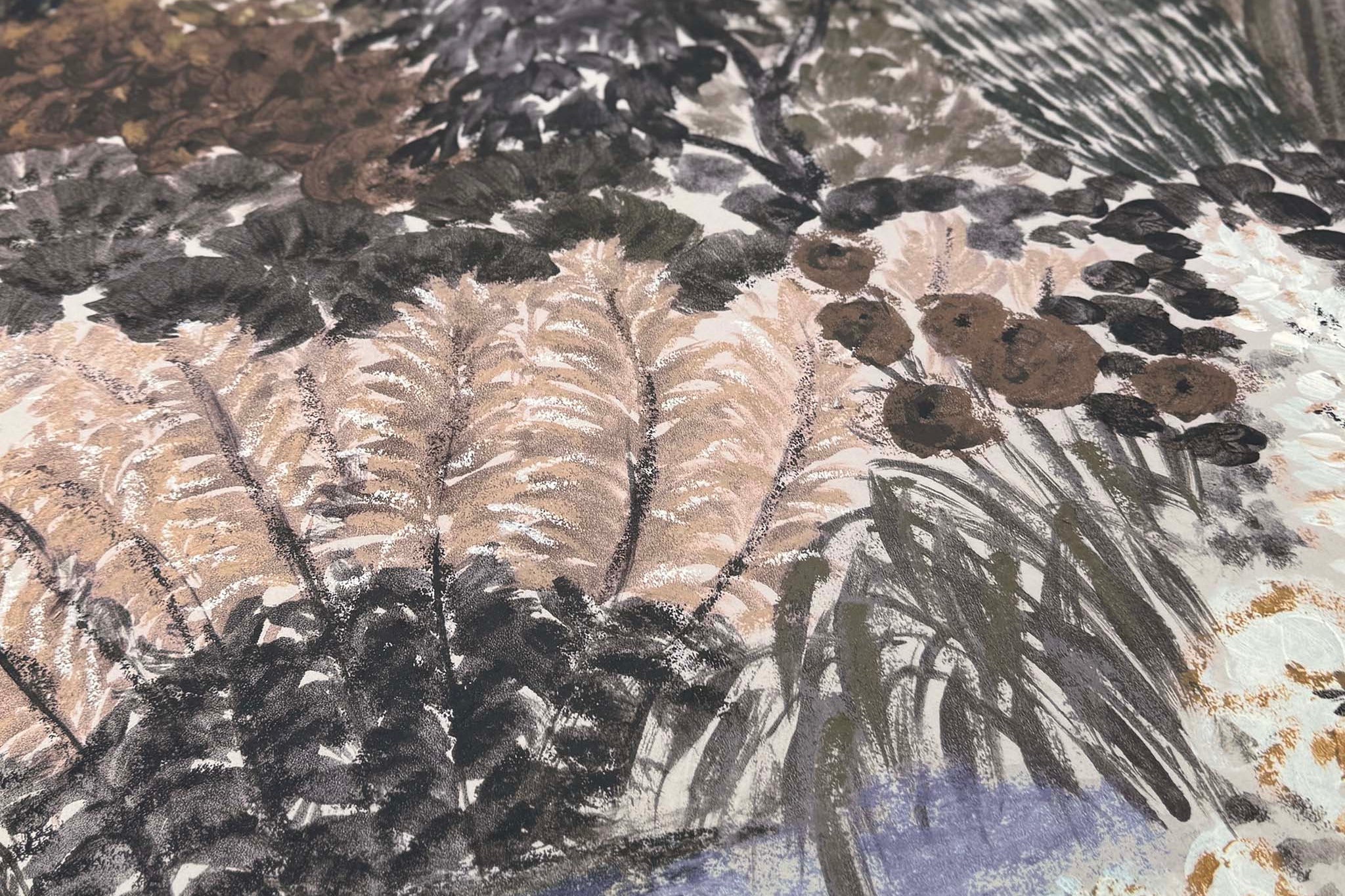 A close up view showing the detail of a matte wallpaper mural which features deep olive, slate, and ash tones