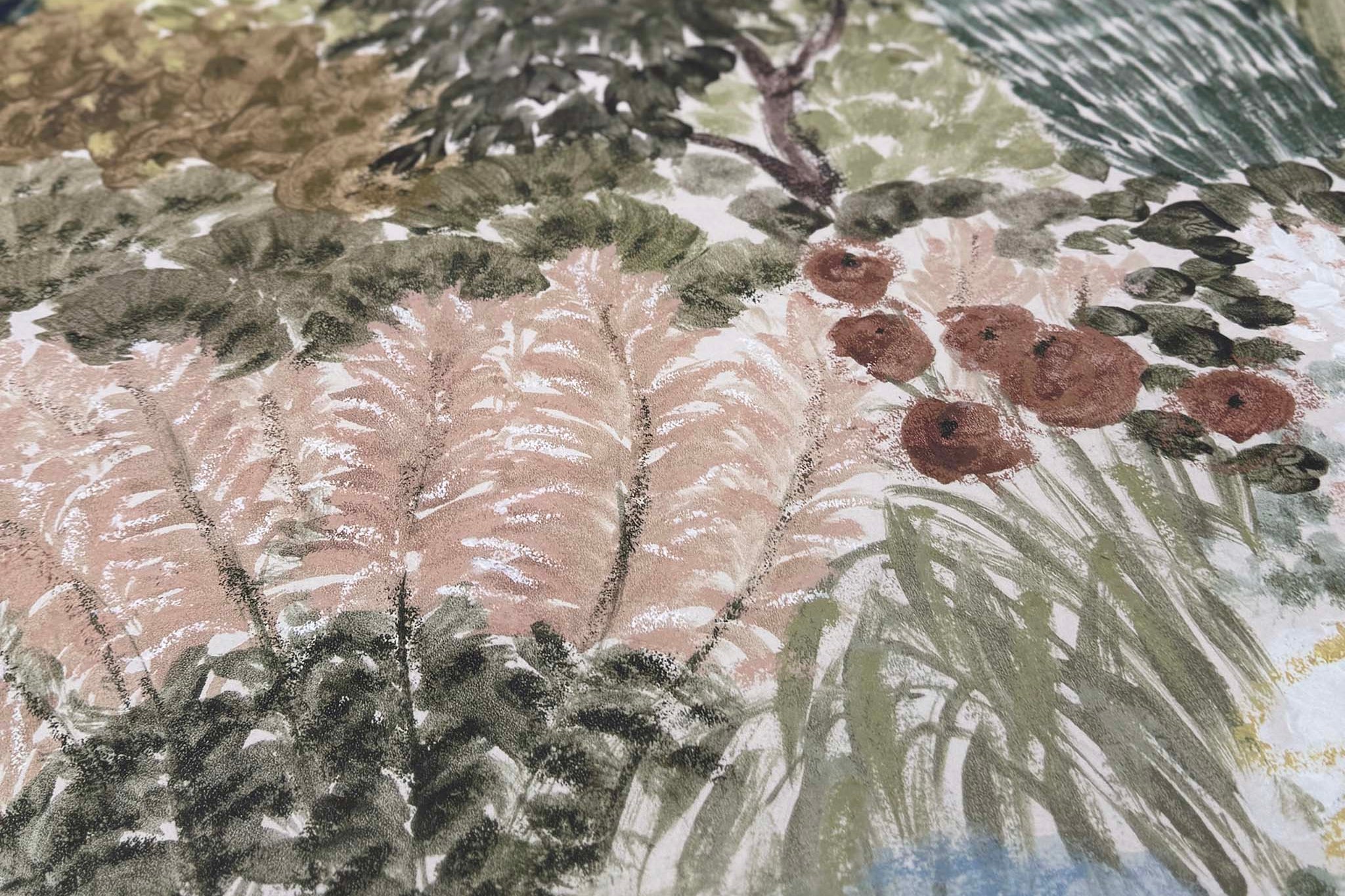 A close up view showing the detail of a matte wallpaper mural which features soft green countryside with cattle and boats