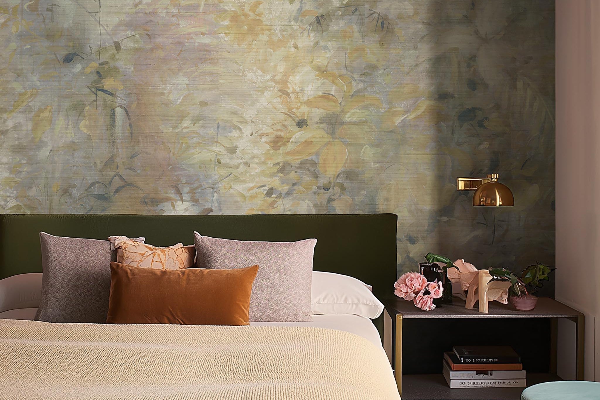 A cropped view of bedroom featuring a panoramic grasscloth wallpaper mural of an abstract forest in lemon and cream.