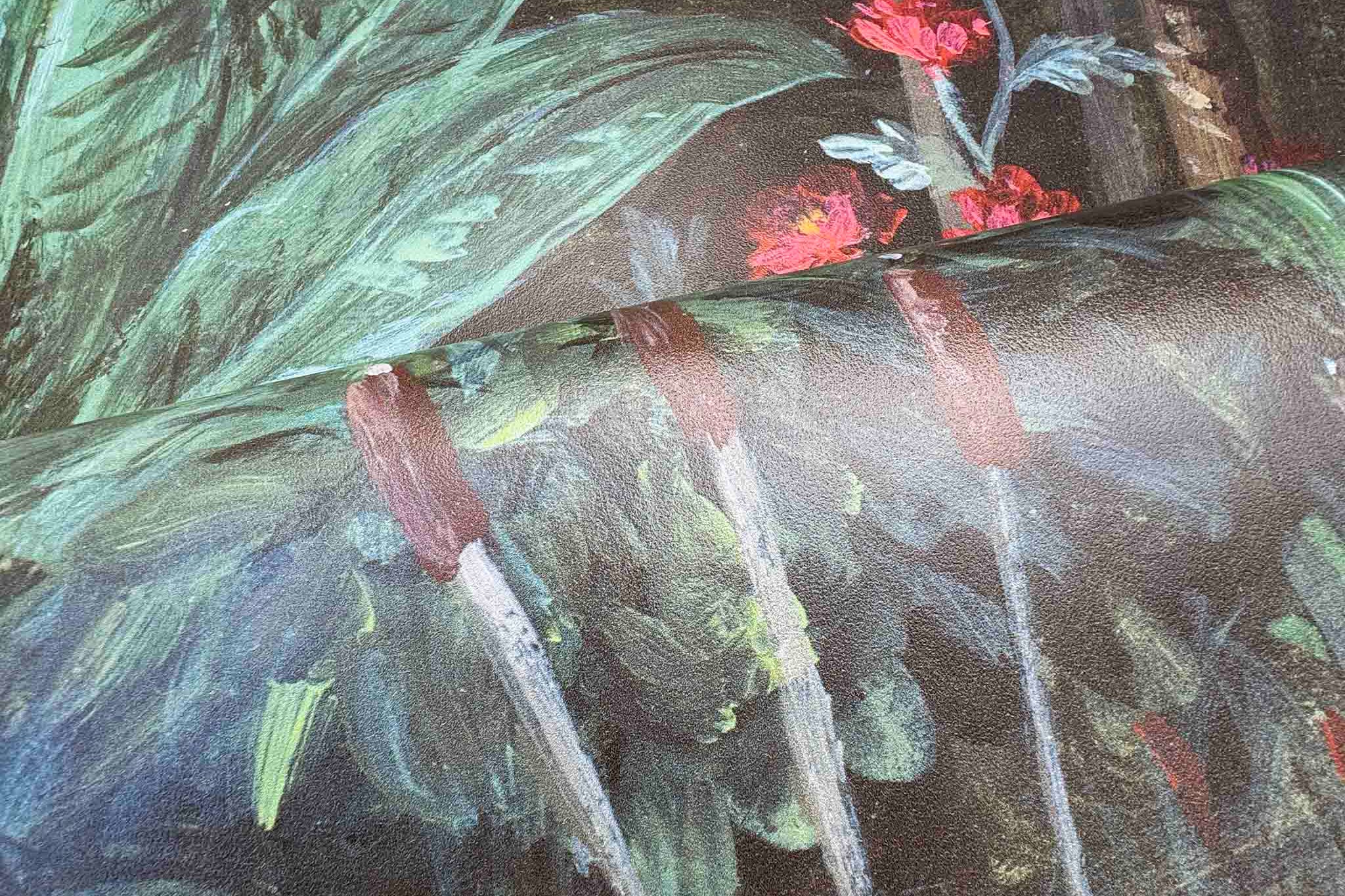 Close-up of a bespoke mural featuring lush green leaves and vibrant red floral accents, printed on durable vinyl.