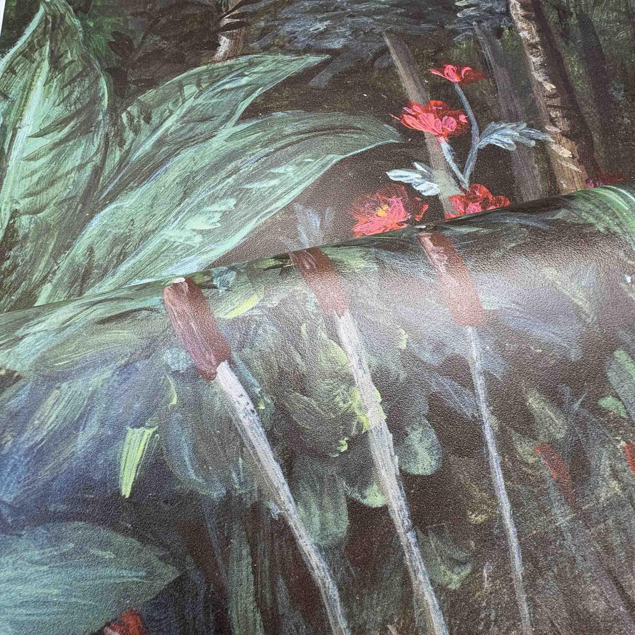 Close-up of a bespoke mural featuring lush green leaves and vibrant red floral accents, printed on durable vinyl.