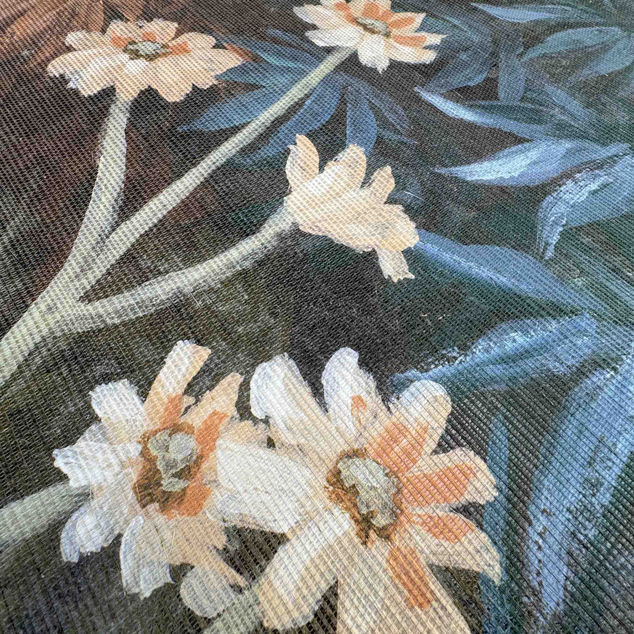 Close-up of floral mural on grasscloth, featuring soft blooms against a dark backdrop with textured weaving.