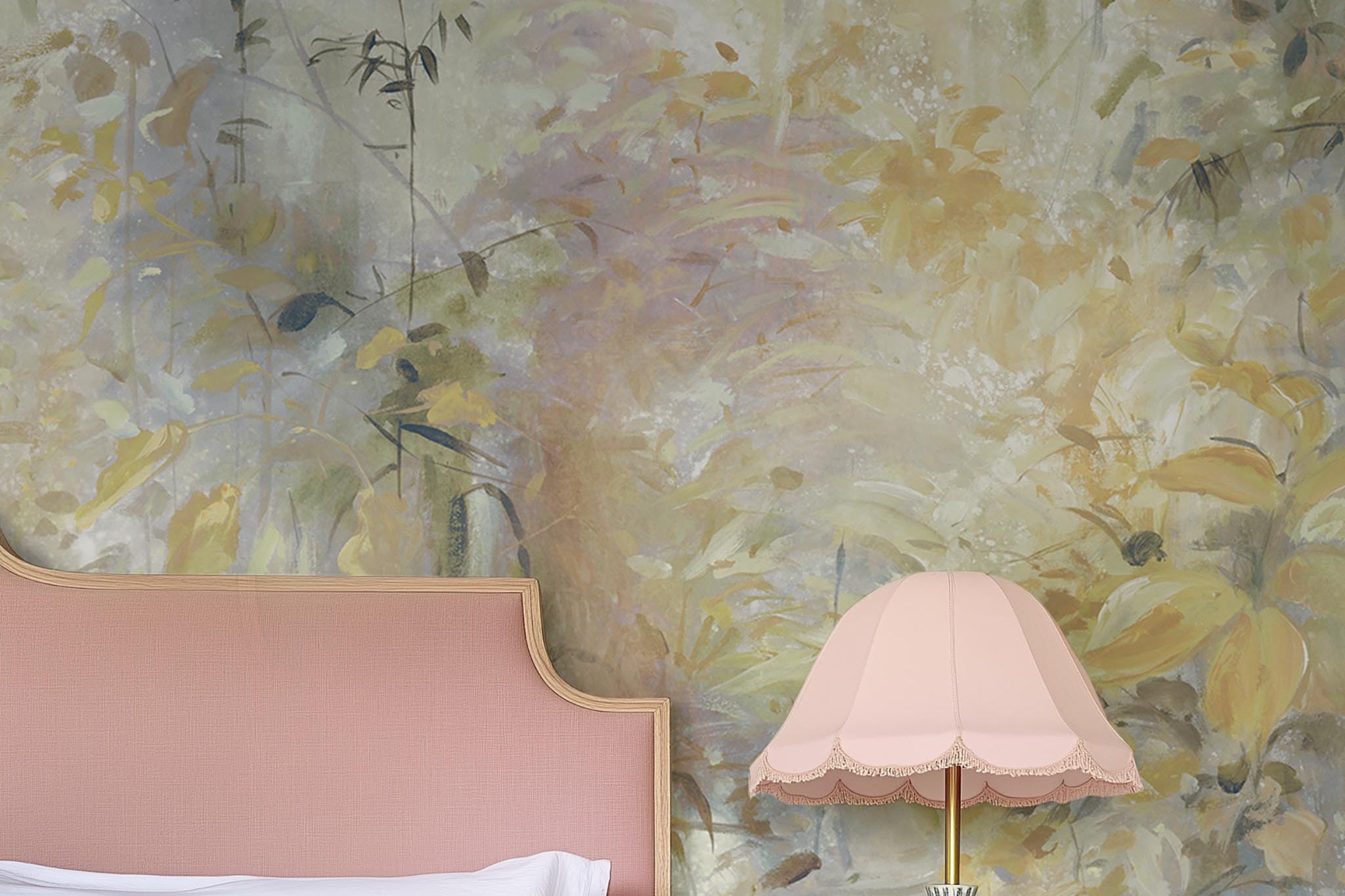 A cropped view of bedroom featuring a panoramic matte wallpaper mural of an abstract forest in lemon and cream.