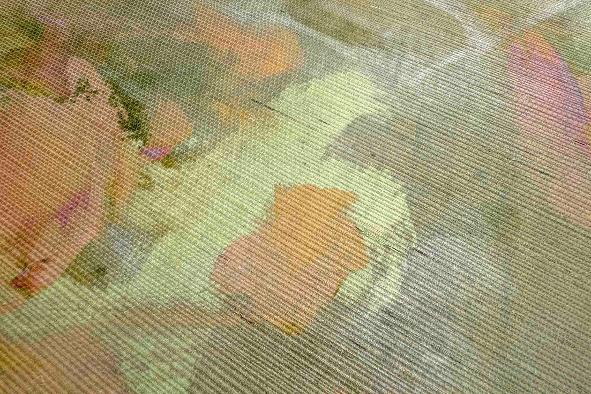 Close-up of a grasscloth wallpaper mural featuring abstract marks in honeyed golds, soft pinks, and lush greens.