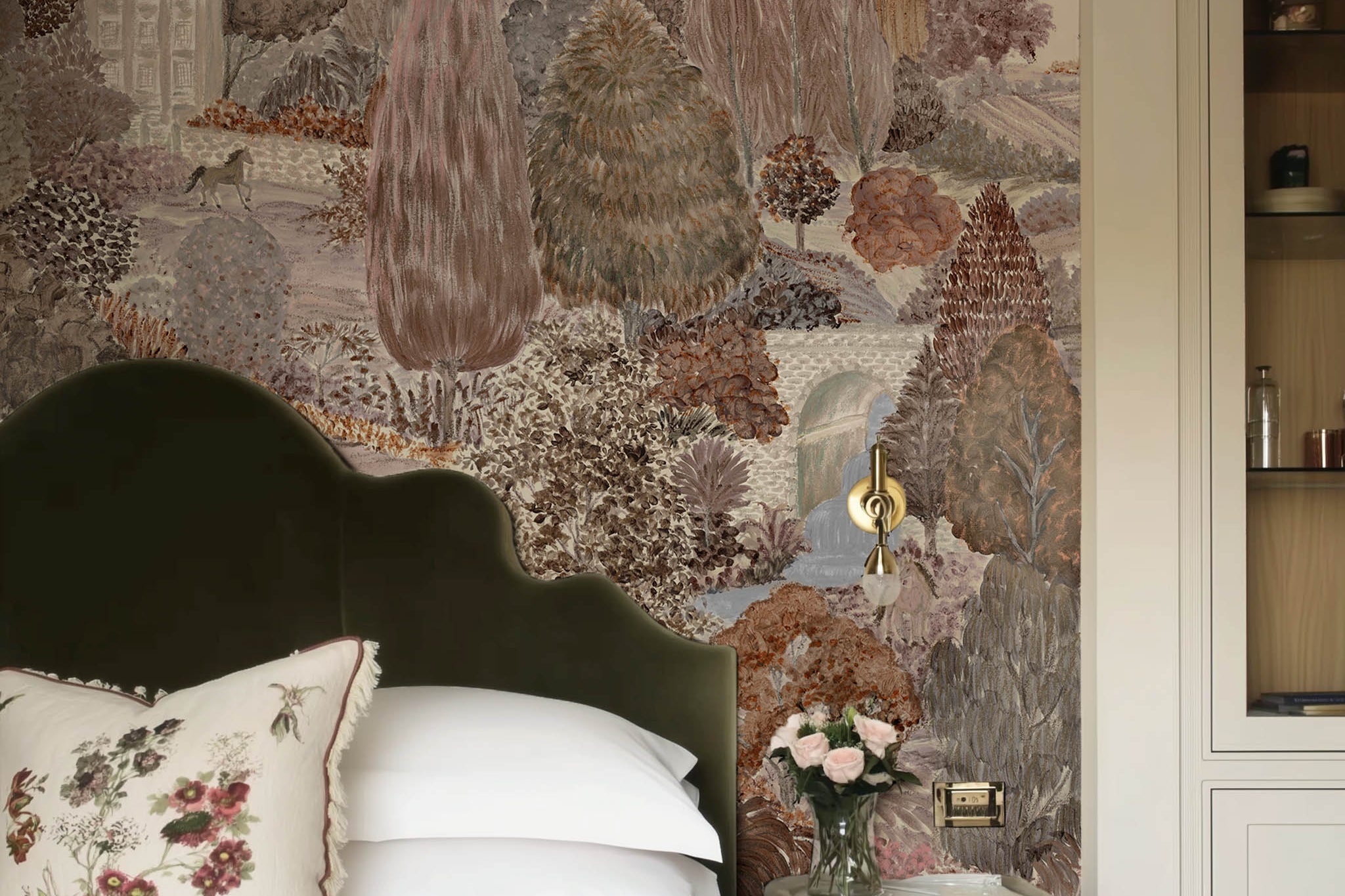 A view of a bedroom featuring a panoramic matte wallpaper mural of warm clays, soft plum, and rusted green landscape