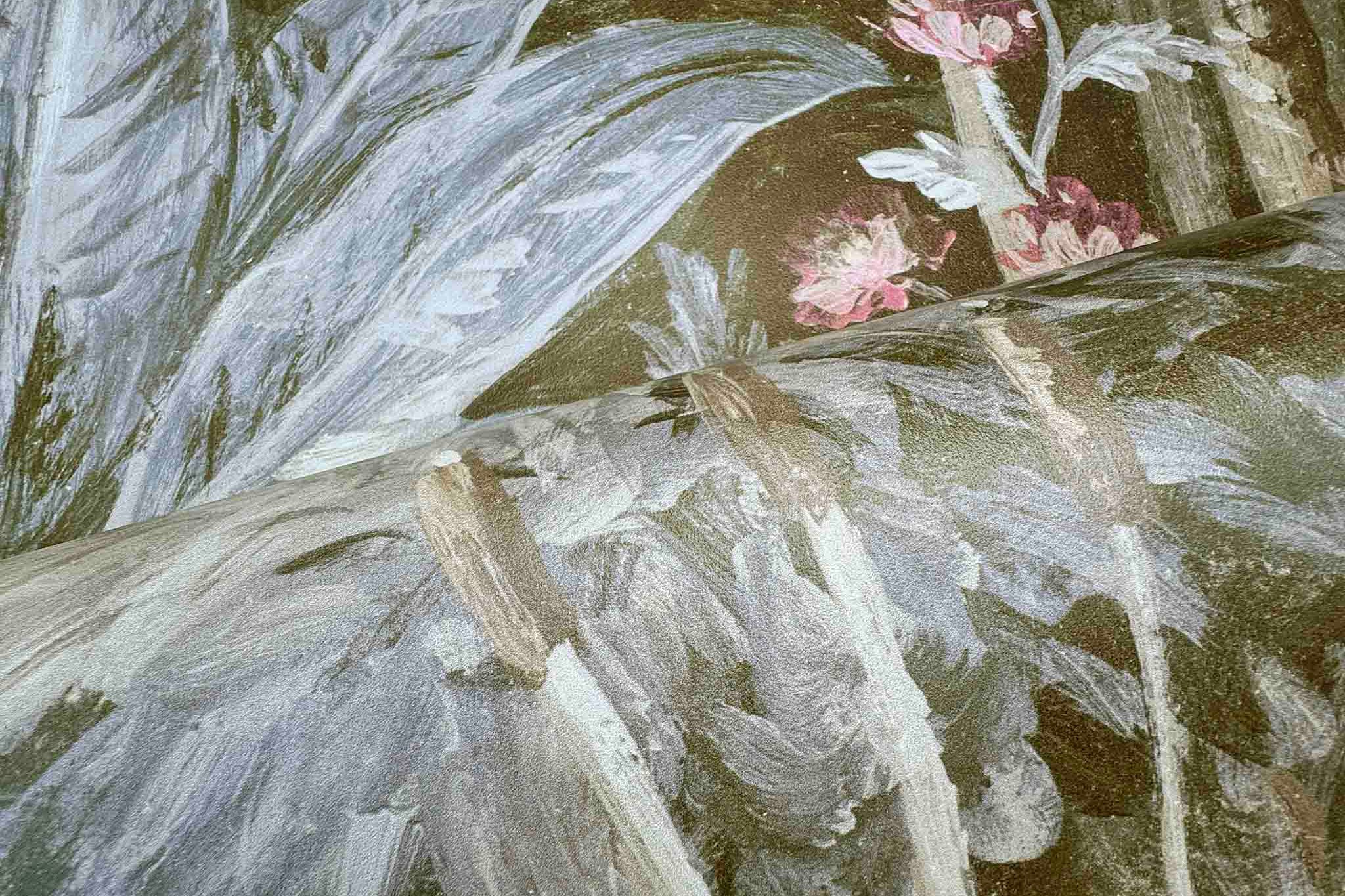 Close-up of a bespoke designer floral wallpaper mural, showcasing tropical foliage and soft ecru and grey tones.