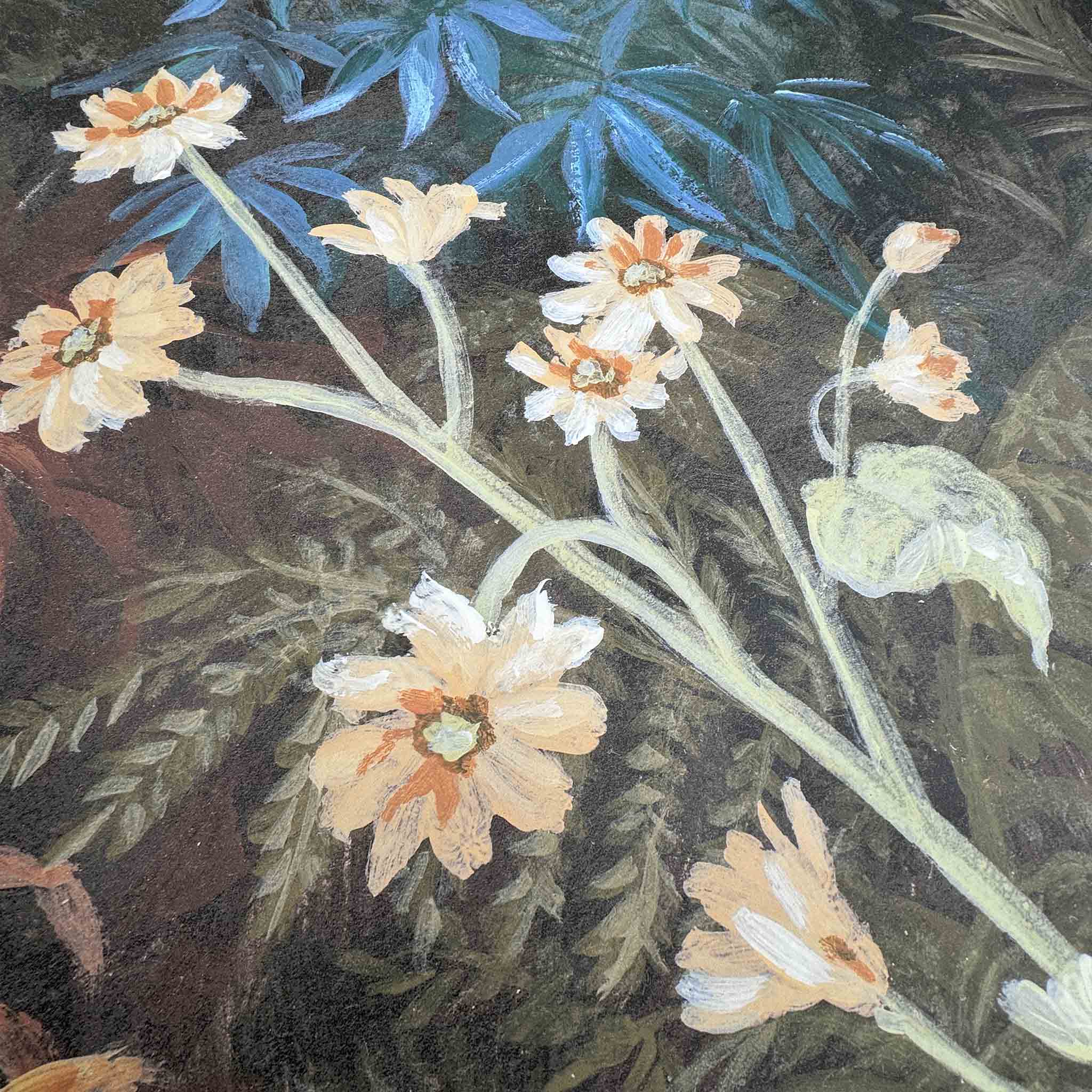 Close-up of a hand-painted floral wallpaper mural featuring pale yellow flowers against a dark green background.