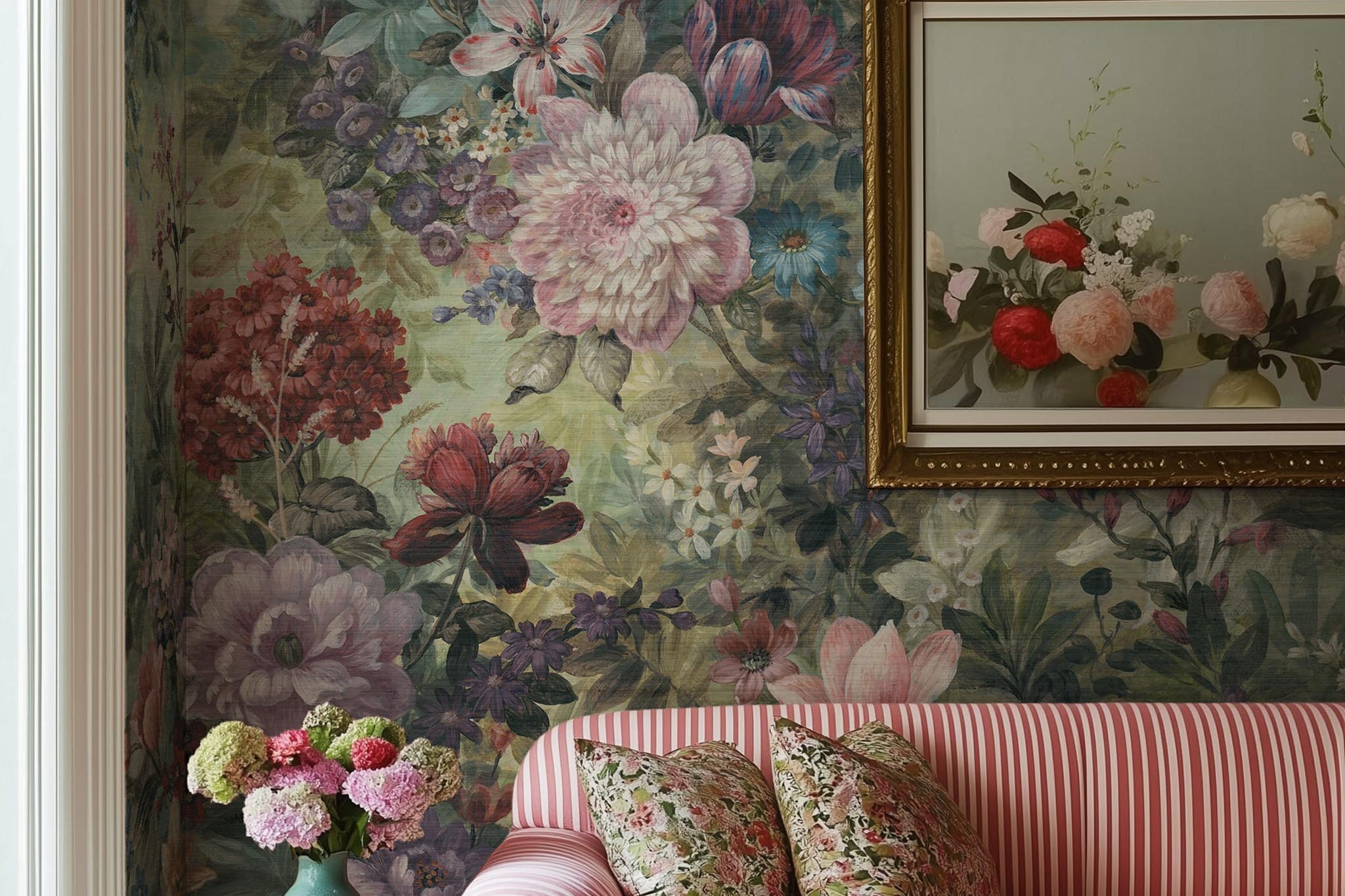 A cropped view of living room featuring a panoramic grasscloth wallpaper mural of a floral tapestry in rich jewel tones.