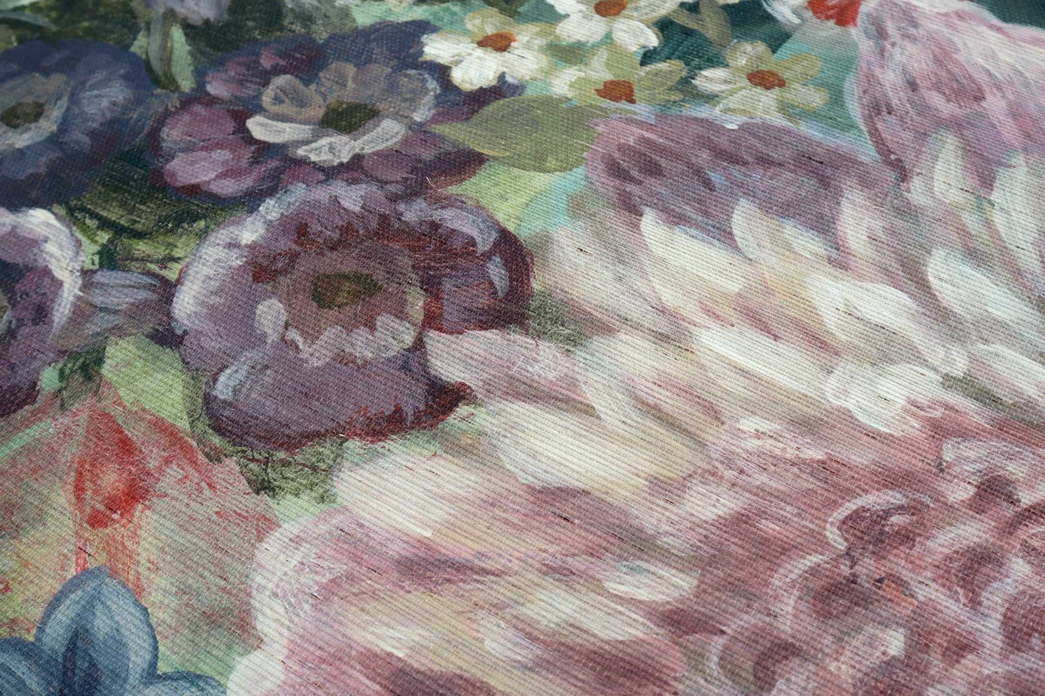 Close-up of a vibrant floral mural on grasscloth, featuring rich greens, reds, purples, and soft pinks.