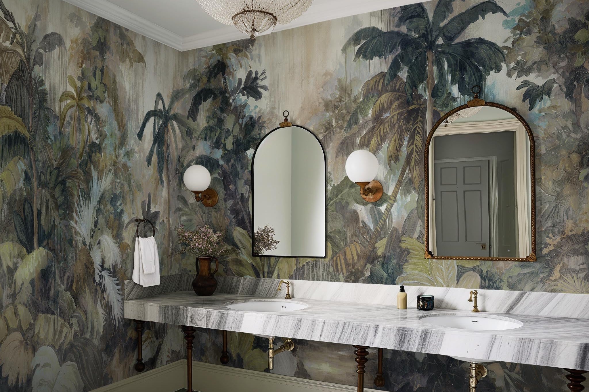 An interior bathroom featuring a panoramic vinyl wallpaper mural of a tropical scene in sage and parchment.