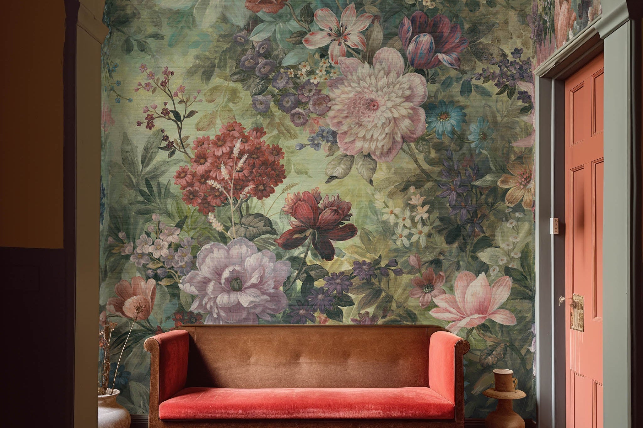 An interior sitting area featuring a panoramic grasscloth wallpaper mural of a floral tapestry in rich jewel tones.