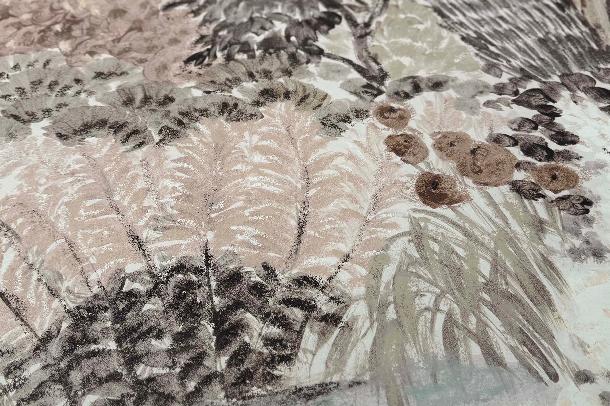 A close up view showing the detail of a matte wallpaper mural which features almond, dusty rose, and misty tones