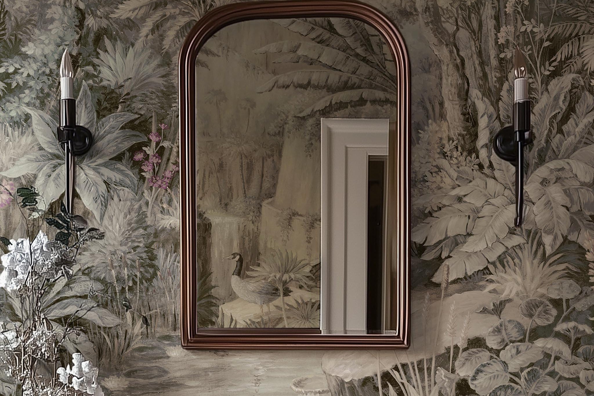 A cropped view of bathroom featuring a panoramic vinyl wallpaper mural of a jungle vista in sepia and blush.