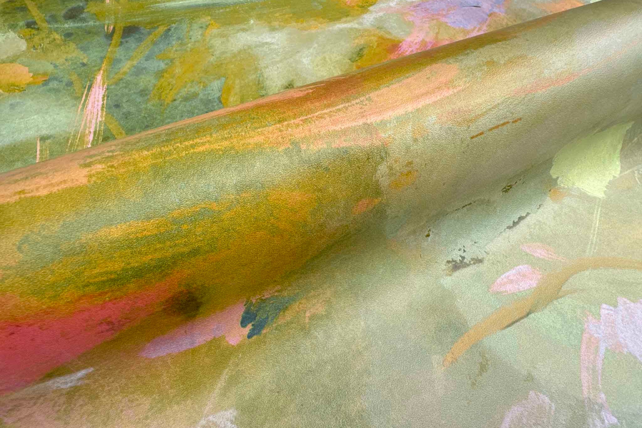 Close-up of a vibrant, abstract hand-painted wallpaper mural featuring warm golds, pinks, and greens on washable vinyl.