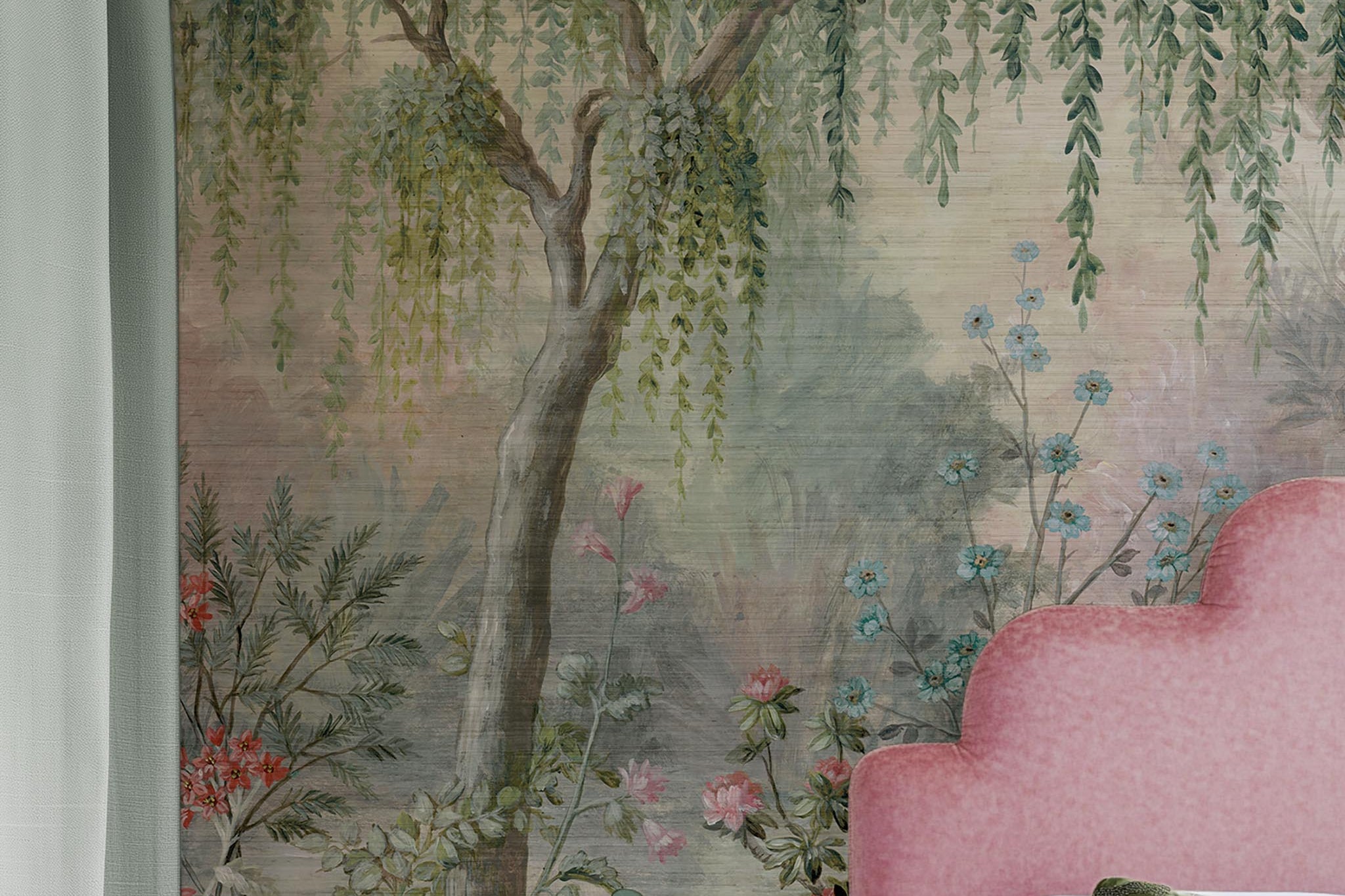 A cropped view of bedroom featuring a panoramic grasscloth wallpaper mural of a lakeside garden scene in mint and pink.