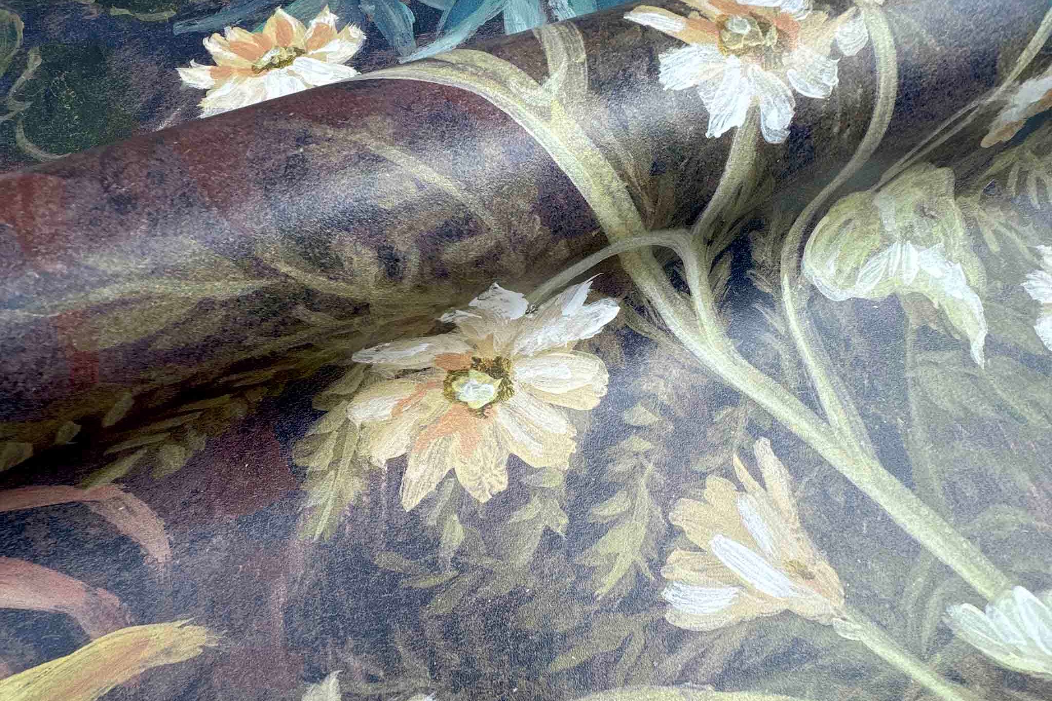 Close-up of a bespoke printed wallpaper mural featuring soft florals in lush greens and earthy tones on durable vinyl.
