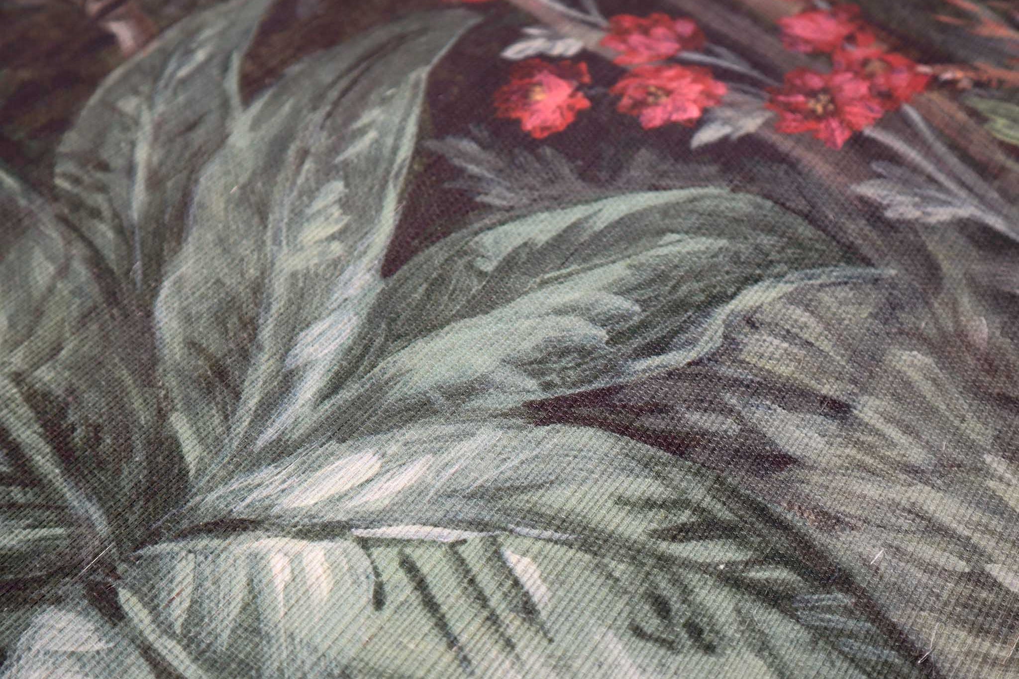 Close-up of lush green leaves and red floral accents on a bespoke designer wallpaper mural, printed on grasscloth.