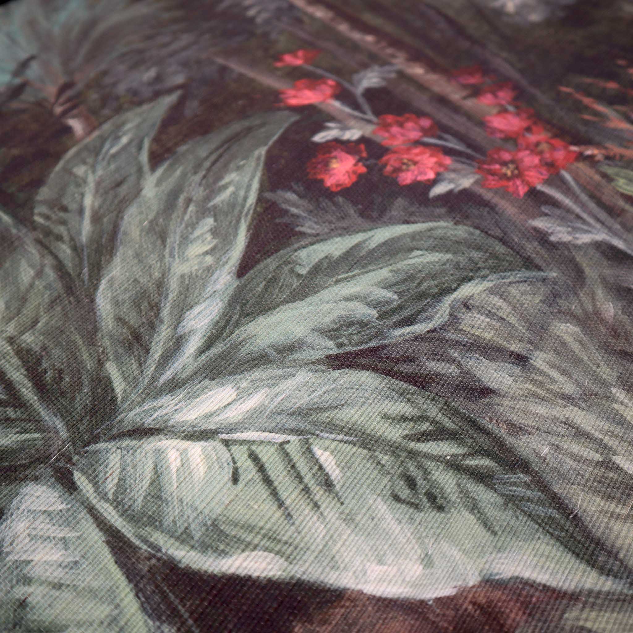 Close-up of lush green leaves and red floral accents on a bespoke designer wallpaper mural, printed on grasscloth.