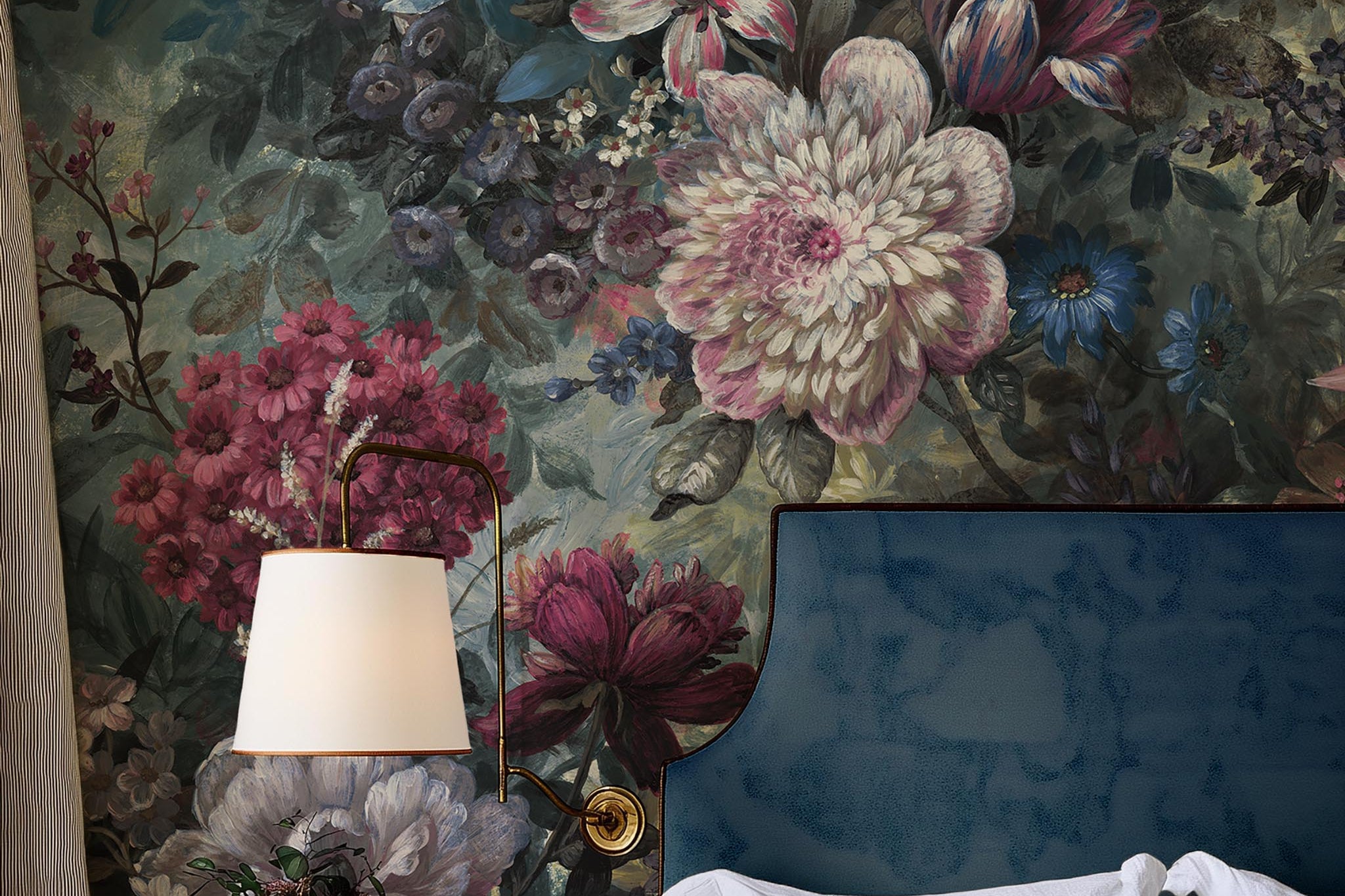 A cropped view of bedroom featuring a panoramic matte wallpaper mural of a floral bloom in crimson and blue.