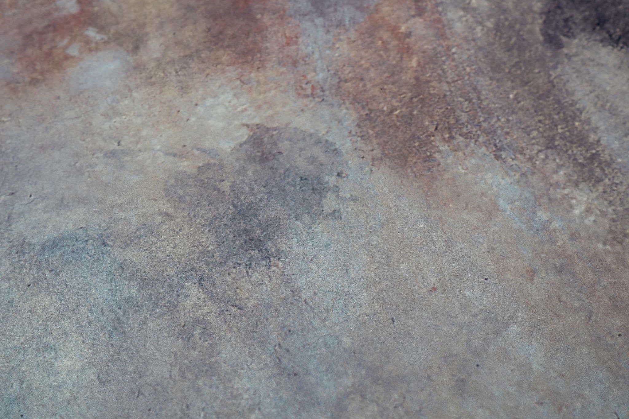 Close-up of a bespoke panoramic wallpaper mural in abstract tones of charcoal, rust, and ochre with a matte finish.