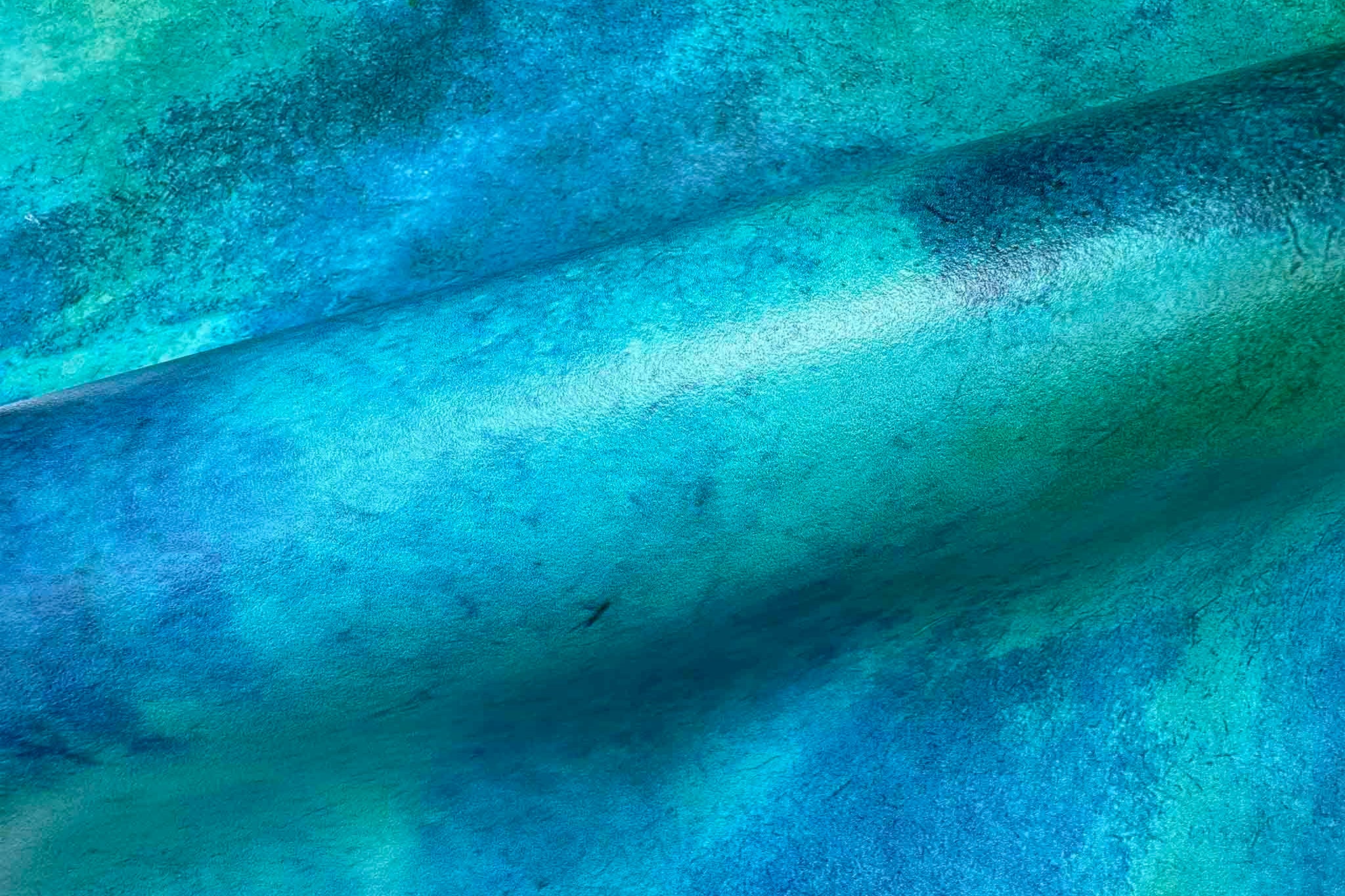 Close-up of vibrant aqua and teal abstract mural printed on durable vinyl, showcasing textured gradient patterns.