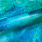 Close-up of vibrant aqua and teal abstract mural printed on durable vinyl, showcasing textured gradient patterns.