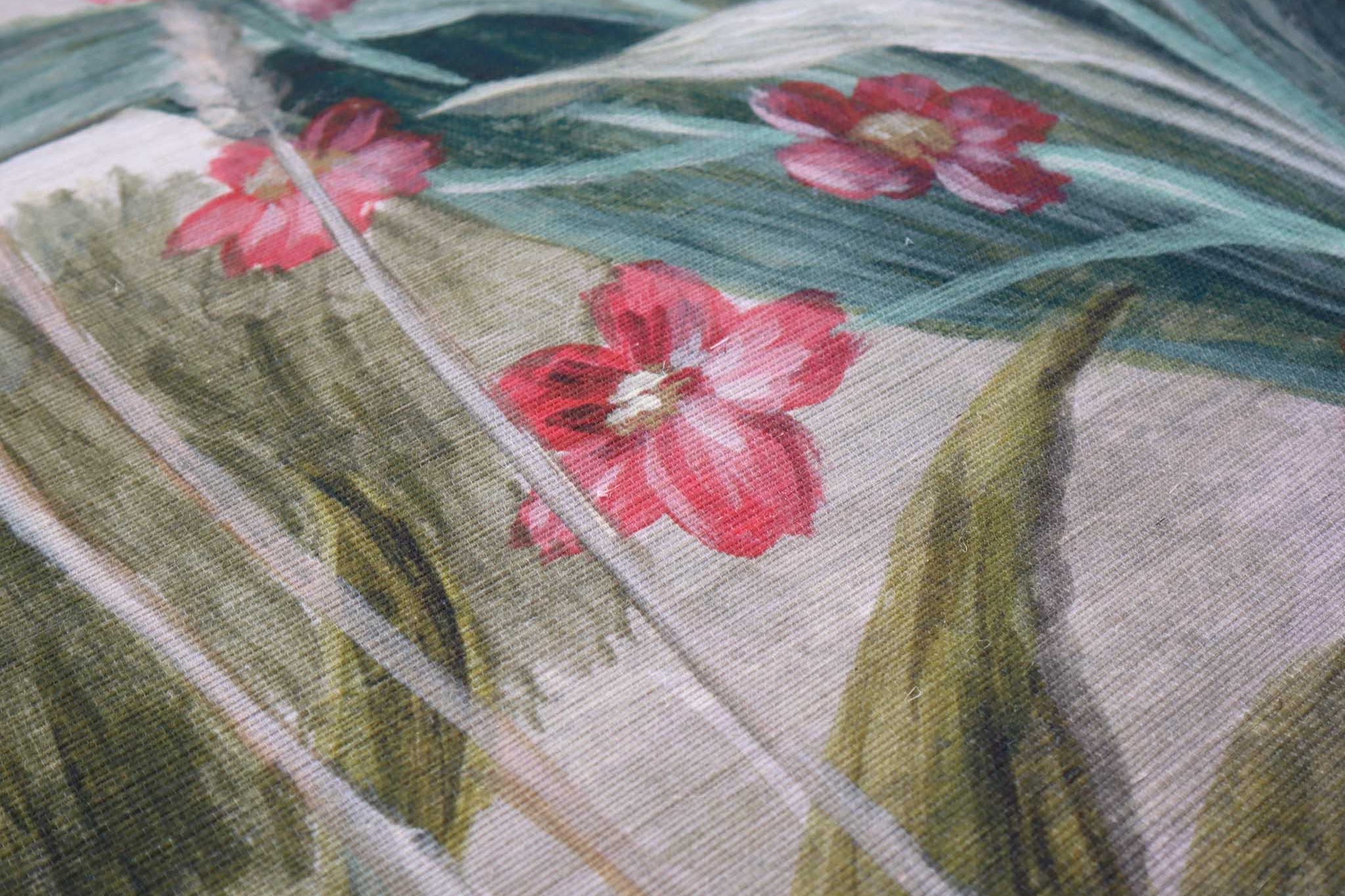 Close-up of a hand-painted floral wallpaper mural with vibrant pink flowers and green foliage on textured grasscloth.