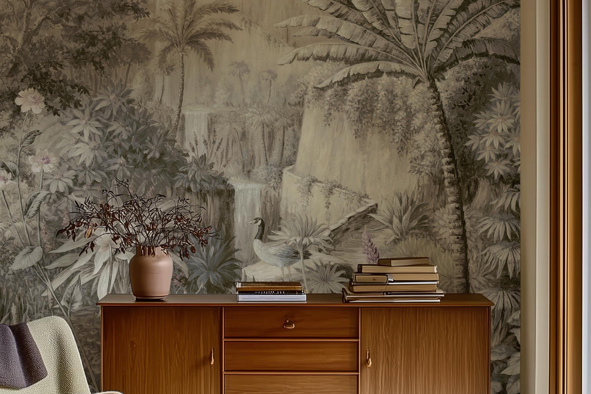 A cropped view of sitting area featuring a panoramic matte wallpaper mural of a jungle vista in sepia and blush.
