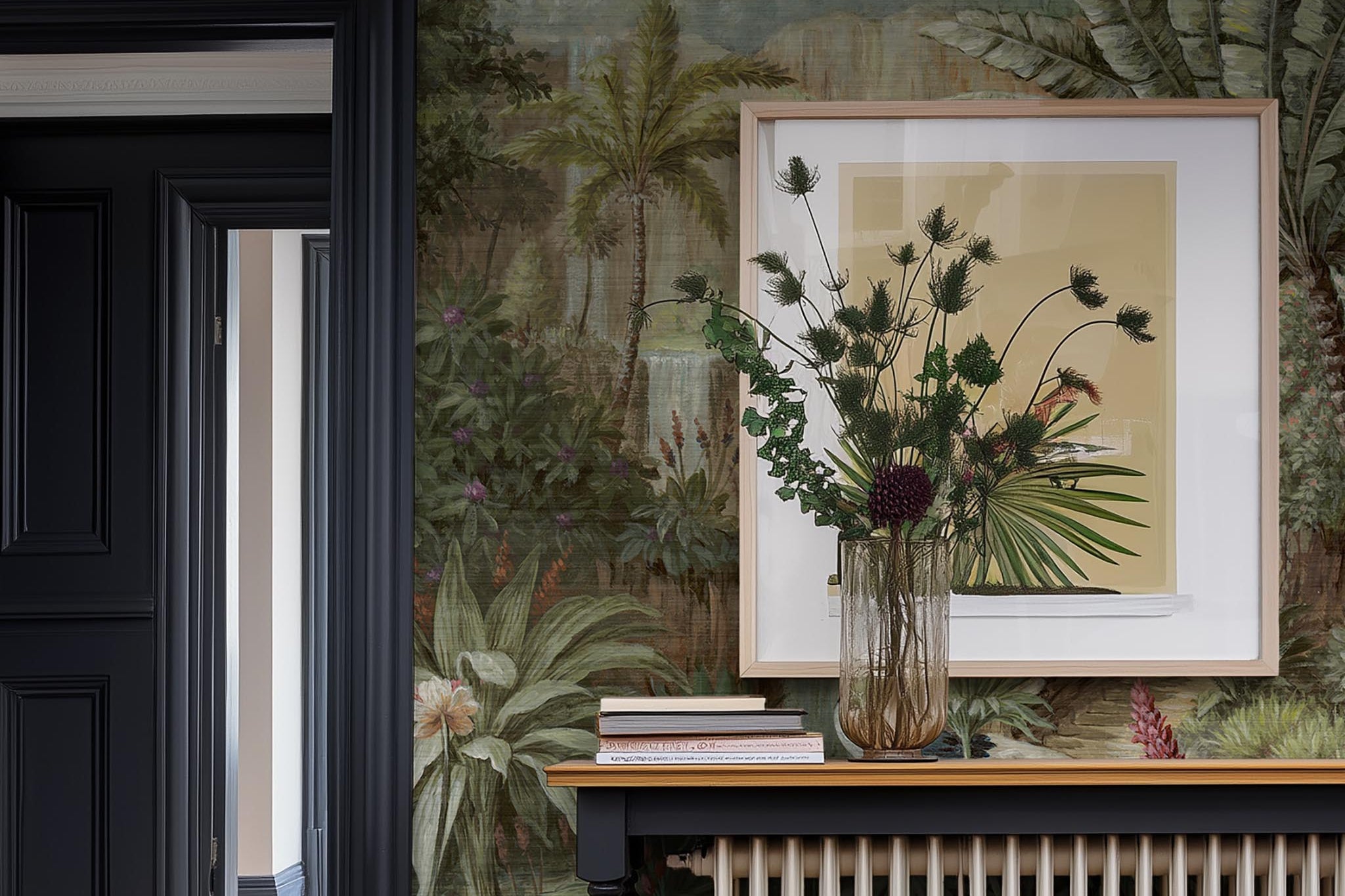 A cropped view of hallway featuring a panoramic grasscloth wallpaper mural of a tropical scene in green and pink.