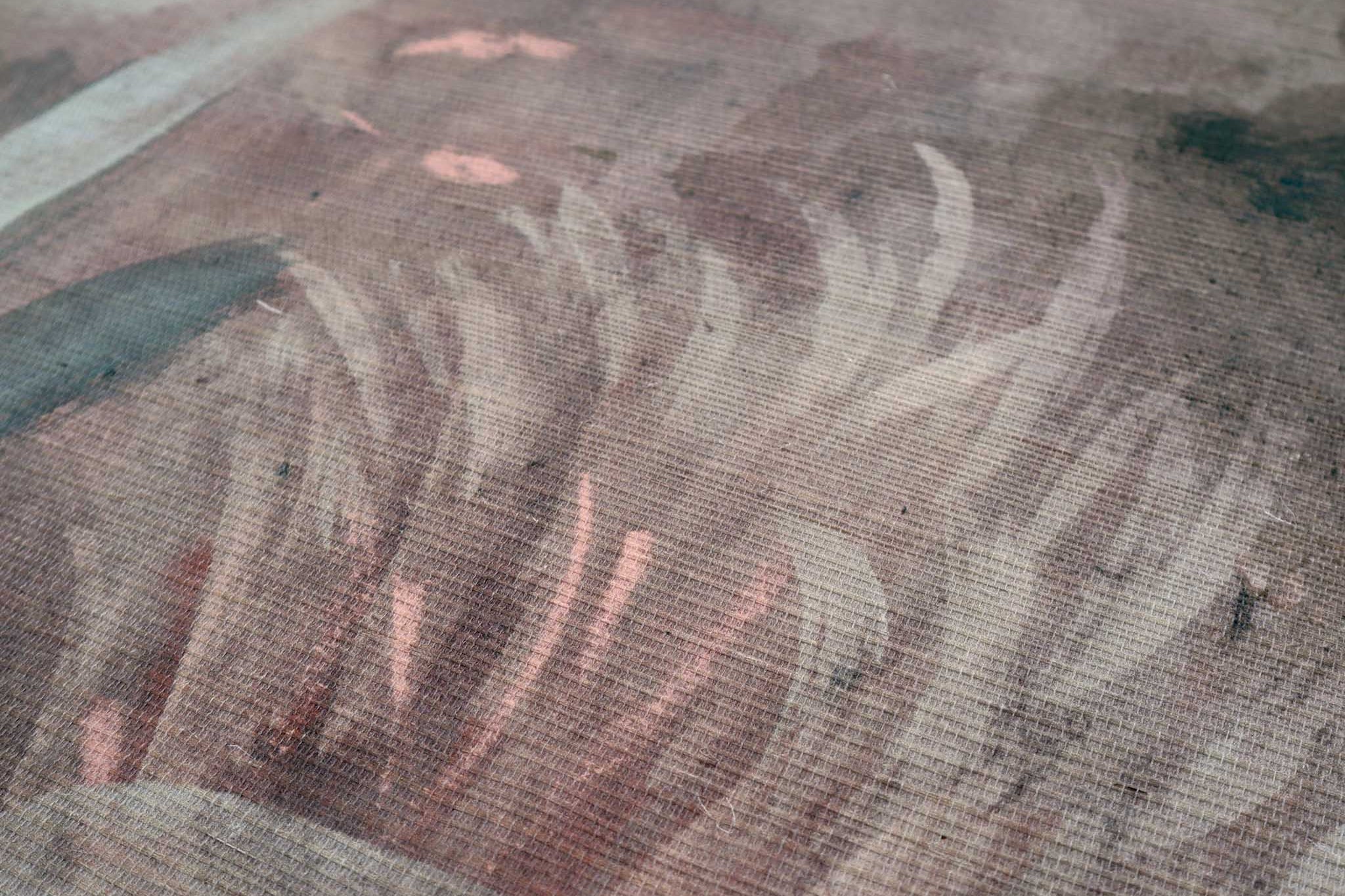 Close-up of a bespoke printed wallpaper mural featuring soft pastels and earthy tones finished on a grasscloth texture.