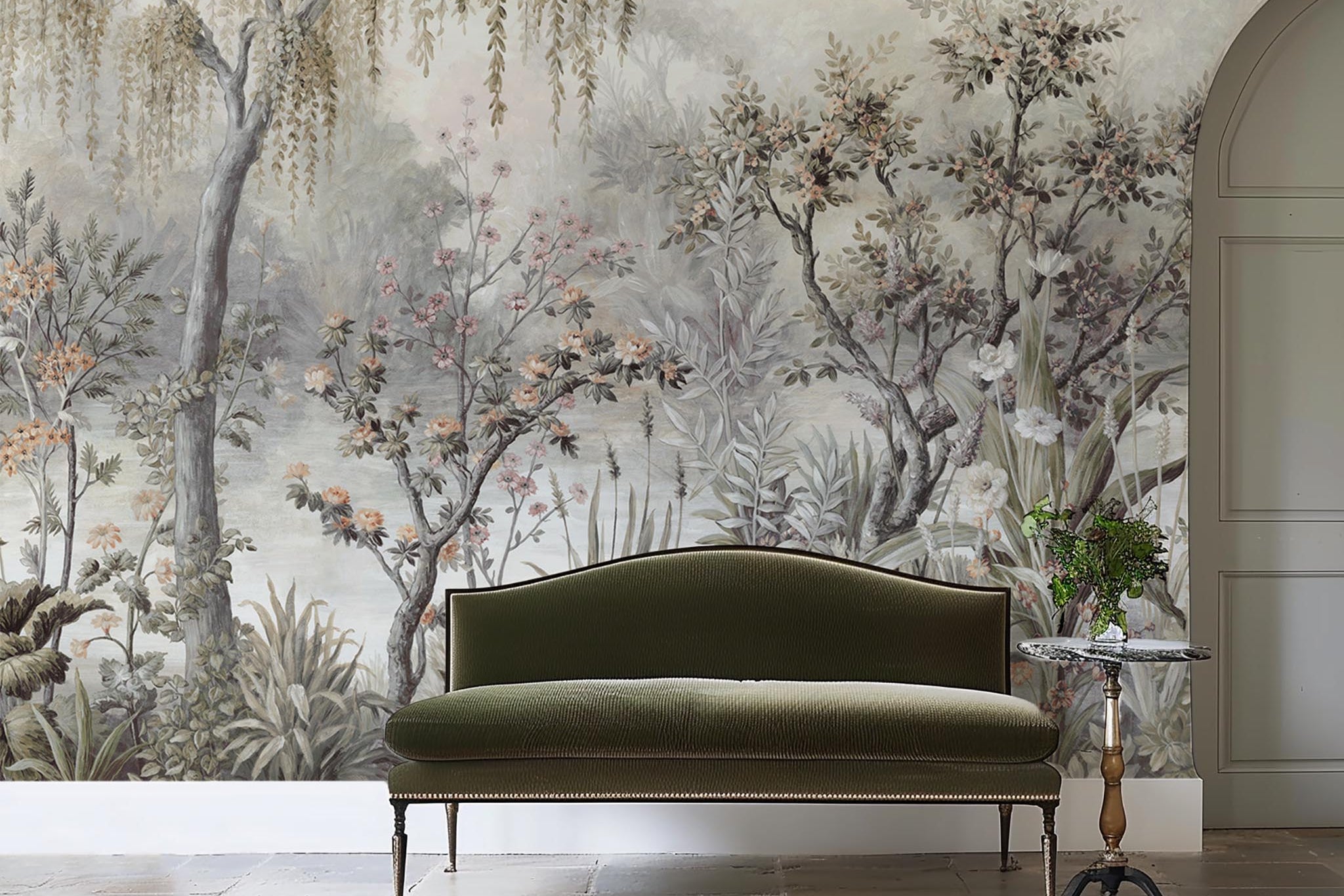 An interior sitting area featuring a panoramic vinyl wallpaper mural of a lakeside scene in grey and peach.