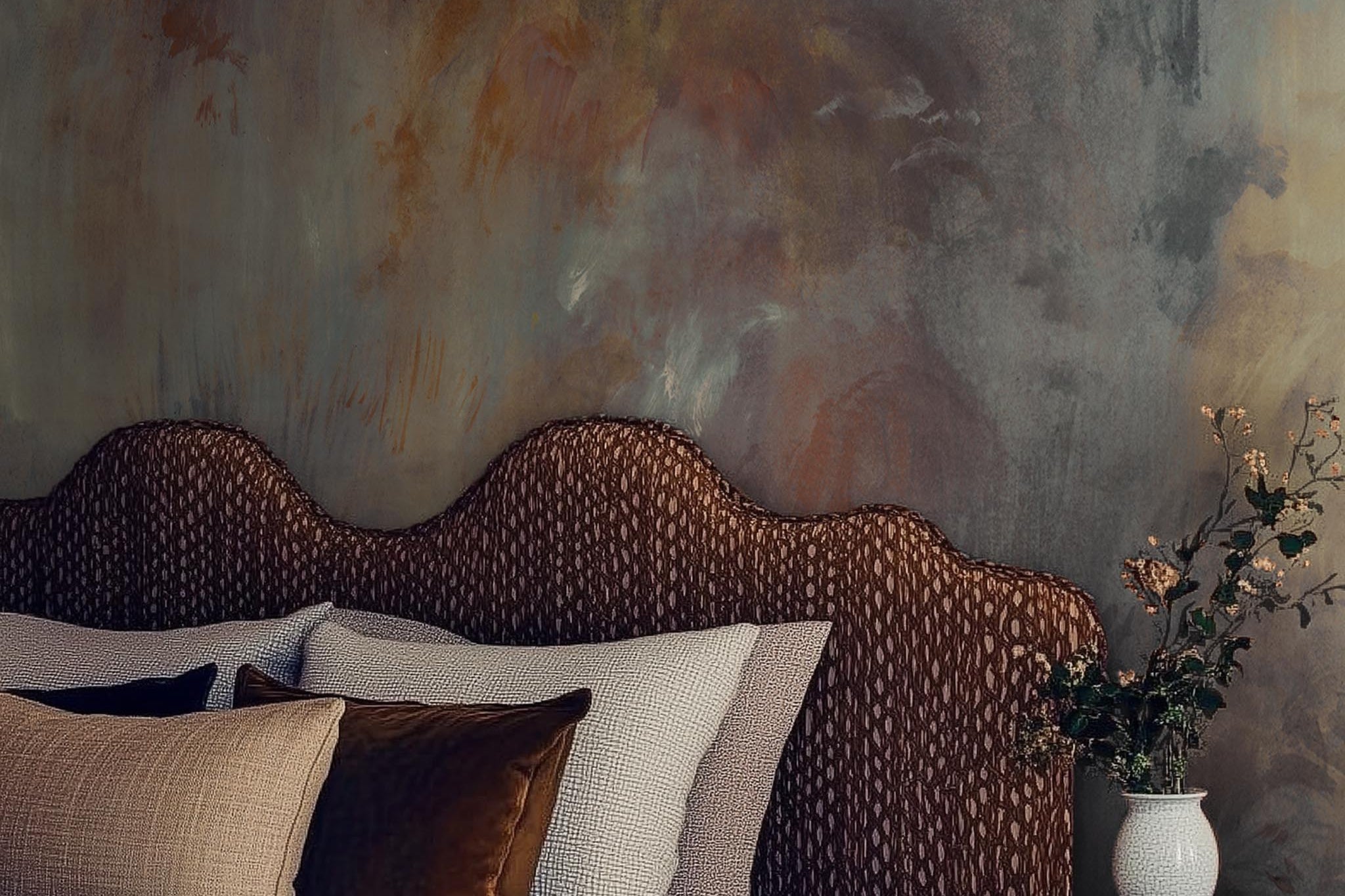 A cropped view of bedroom featuring a panoramic matte wallpaper mural of an abstract haze in charcoal and ash.