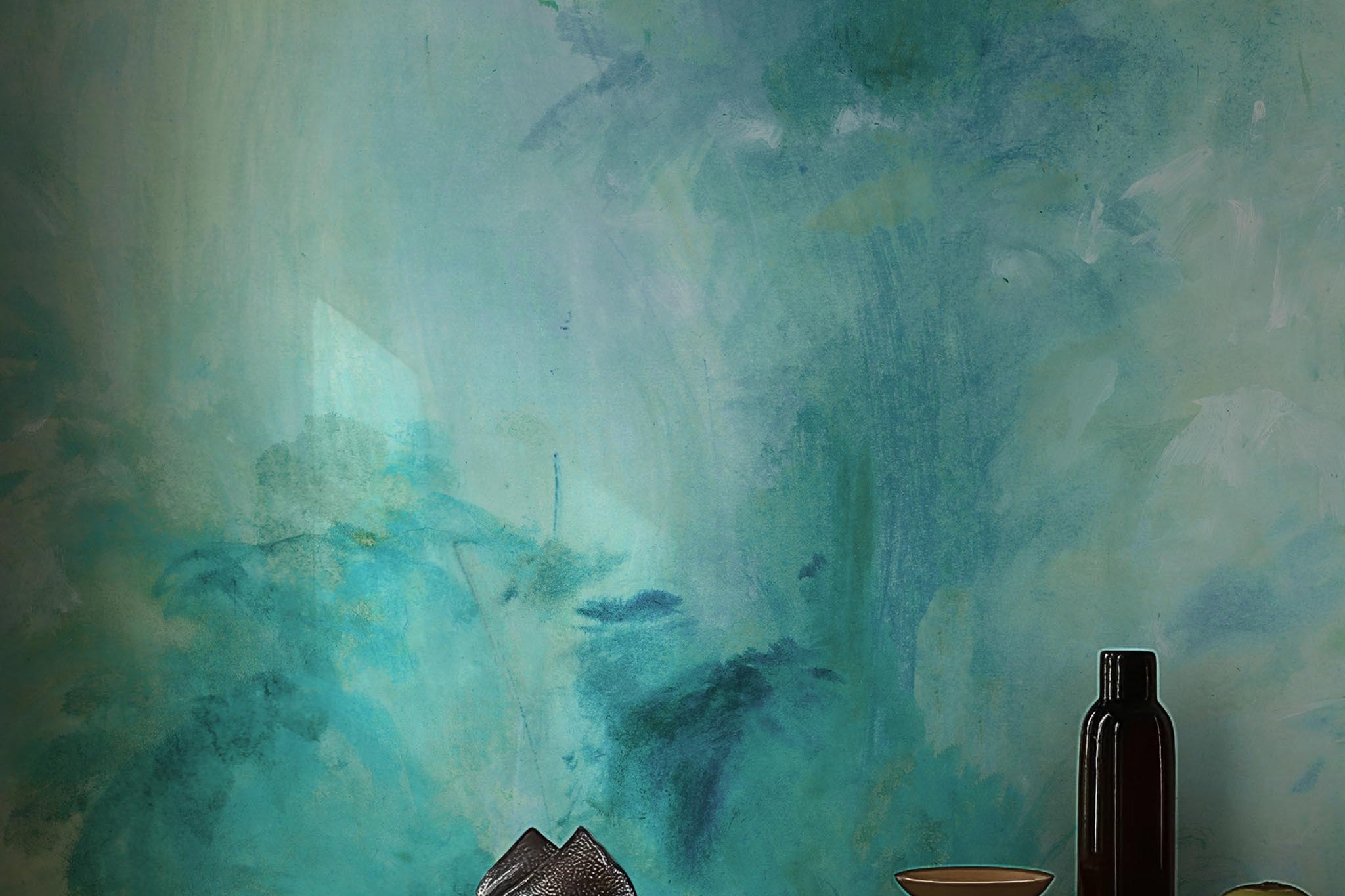 A cropped view of living room featuring a panoramic matte wallpaper mural of an abstract wash in aqua and jade.
