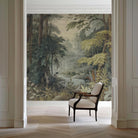 An interior sitting area featuring a panoramic grasscloth wallpaper mural of a misty woodland in sage and ochre.