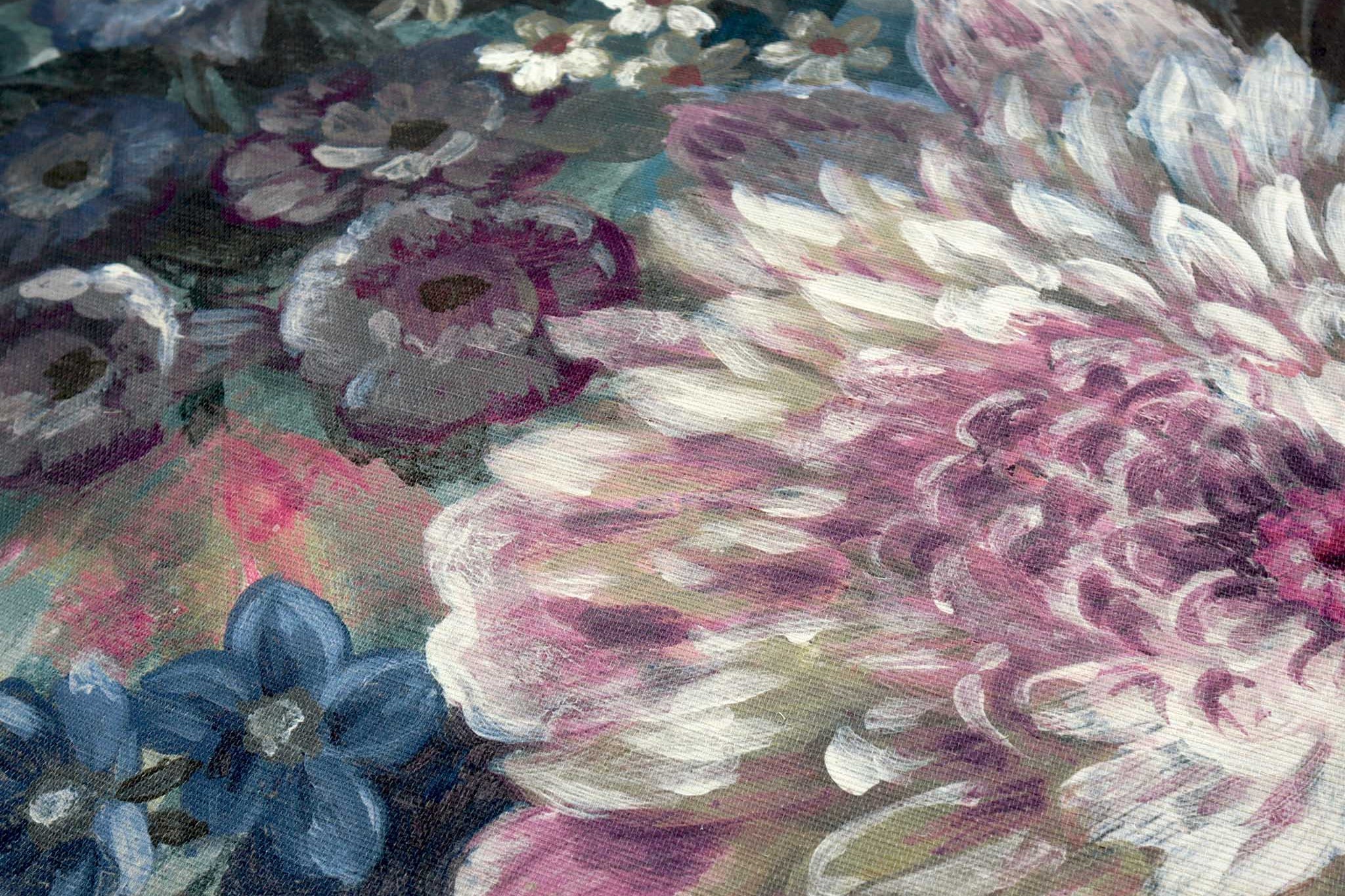 Close-up of textured grasscloth wallpaper mural featuring soft florals in deep jewel tones and soft blush hues