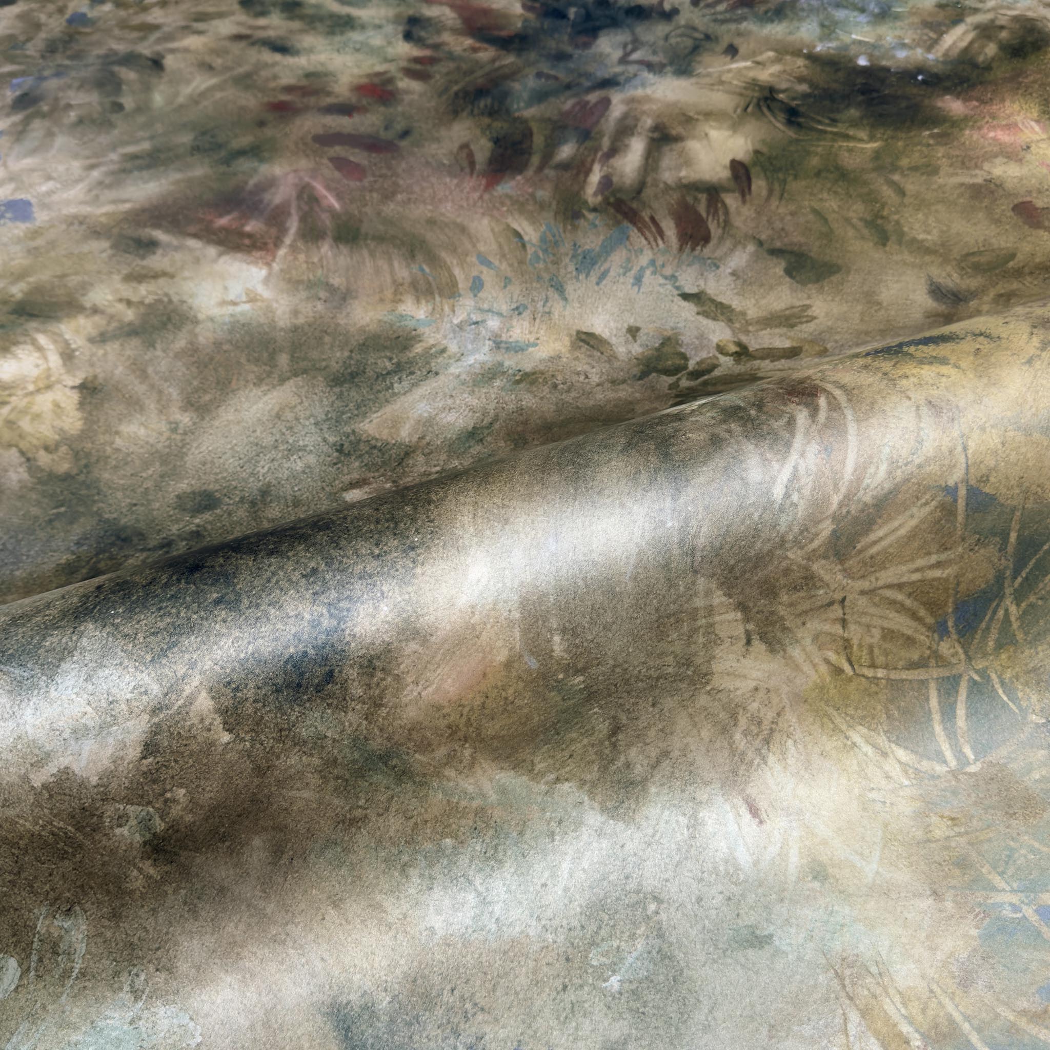 A close up view showing the detail of a pearlescent wallpaper mural which features misty mural in fennel, sage, olive, indigo and ochre.