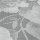 A close up view showing the detail of a matte wallpaper mural which features misty whites on dove grey floral