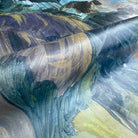 Close-up of a vibrant rainforest wallpaper mural printed on vinyl, with swirling earthy tones in an abstract style.