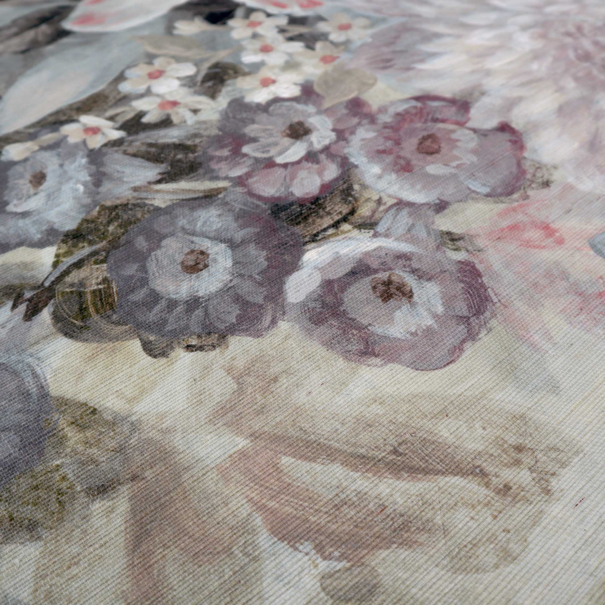 Close-up of a bespoke painted wallpaper mural featuring lush florals in soft blush pinks and muted greens on grasscloth.