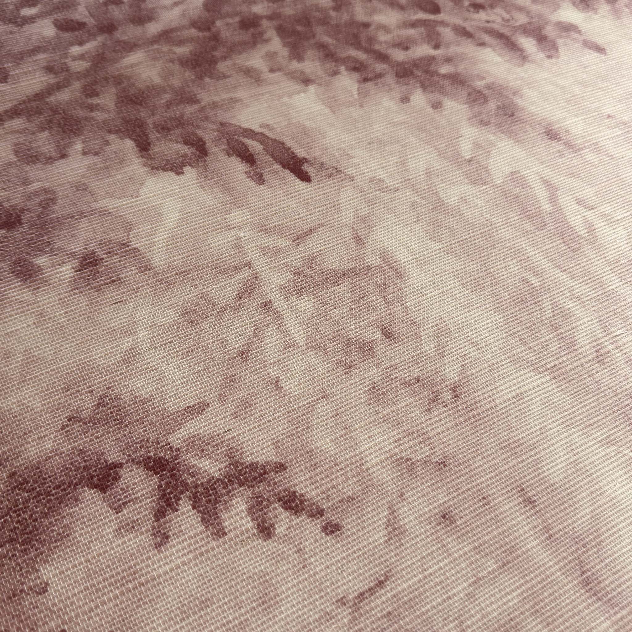 A close up view showing the detail of a grasscloth wallpaper mural which features rose forest