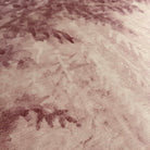 A close up view showing the detail of a grasscloth wallpaper mural which features rose forest