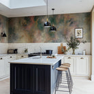 A cropped view of kitchen featuring a panoramic vinyl wallpaper mural of an abstract haze in green and blush.