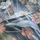 Close-up of a bespoke floral wallpaper mural, featuring soft grey, warm peach, and muted blue tones on durable vinyl.