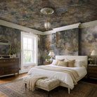 An interior bedroom featuring a panoramic pearlescent wallpaper mural of misty mural in fennel, sage, olive, indigo and ochre.