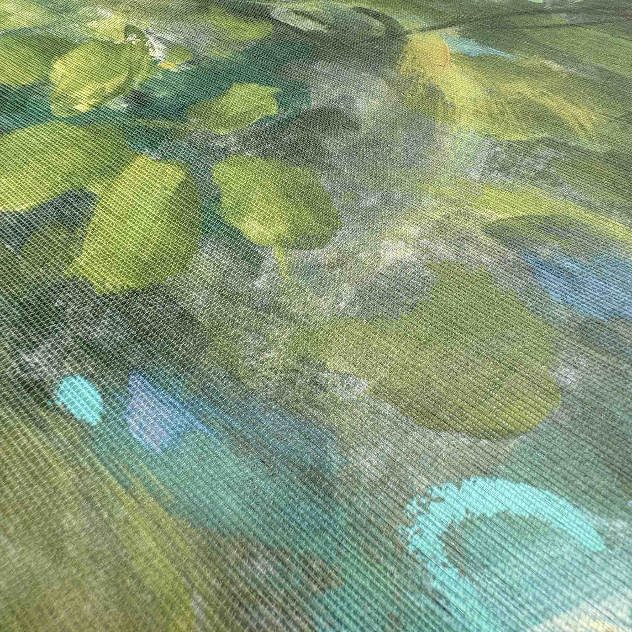 Close-up of a bespoke, hand-painted wallpaper mural featuring lush greens and blues on a textured grasscloth substrate.