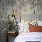 A cropped view of bedroom featuring a panoramic matte wallpaper mural of a lakeside scene in grey and peach.